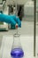 Chemical analysis by titration of blue solution.