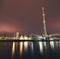 Chemical factory near the river at night