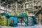 Chemical factory. Thermoplastic production line and packing machinery in large area of industrial hall