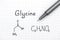 Chemical formula of Glycine with black pen.