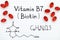 Chemical formula of Vitamin B7 Biotin with red pills.