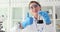 Chemical industrial laboratory scientist holding black liquid crude oil in flask and thumbs up