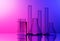 Chemical lab equipment - Erlenmeyer flask, test tubes and glass cylinder - on red and blue background