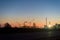 Chemical plant in a silhouette image at sunset, the glowing light of the chemical industry at sunset and twilight sky, the field