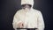 Chemical scientist in protective clothing using digital tablet for computing