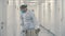 Chemist carries instruments in metallic barrel for sterilization