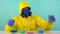 Chemist laboratory assistant in a protective yellow suit, gloves and glasses evaluates flasks with chemical elements