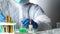 Chemist in laboratory works in chemical reagents