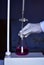 The chemist measures with precision in acid-base titration, adding solutions until neutralization