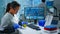 Chemist with protection glass examining various bacteria holding petri dish