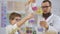 Chemist and pupil makes experiment with dry ice and colorful liquids