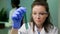 Chemist researcher woman holding test tube with dna liquid