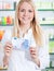 Chemist\'s assistant holding 20 euro