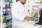 Chemist Scanning Barcode Of Product At Checkout Counter
