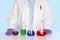 Chemist standing at a desk with chemicals