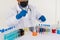 Chemistry  doctor with colorful liquid in a beaker, test tube with various colored chemical liquids in laboratory or scientific re