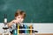 Chemistry. The Science Classroom. Lab microscope and testing tubes. Little children at school lesson. Blackboard for