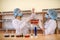 Chemists working in laboratory. Young women in protective uniforms with test tubes making experiments