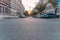 Chemnitz, a bulding crane behind a street with cars and houses at sunrise, ground view