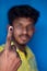 Chennai, India - 5th March 2021: Indian Voter Showing His Hand with voting sign and ink pointing vote for India