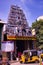 Chennai, India - October 29, 2018: A Three wheeler tuk tuk parked outside of a hindu temple with gods idols carved on the exterior