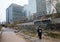 Cheonggyecheon, small river in the center of Seoul. High-rise office buildings. A girl walks along the river