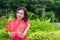 Cheongsam asian woman with red envelopes in hand, Gong xi fatt cai