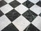 chequered white green and black stone floor background