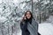 Cherful brunette have conversation while have a walk in winter forest