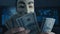 Cherkassy, Ukraine, January 04 2019: anonymous in Guy Fawkes mask recounts bills of dollars earned by hacking in the