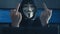 Cherkassy, Ukraine, January 10 2019: Anonymous Hacker in Black Hoodie Hiding his face under mask of Guy Fawkes and