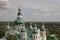 Chernigov, Ukraine. August 15, 2017. Christian orthodox white church with green domes and gold crosses. View from high. Calm sky