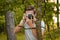 Chernihiv, Ukraine - July 26, 2019: A guy in the forest takes pictures with an old camera