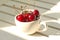 Cherries Chile in Heart-shaped mug on wood .