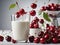 Cherries falling into milk