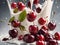 Cherries falling into milk