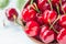 Cherries fruit in bowl on white background.