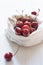 Cherries in linen bag on wooden table