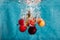 Cherries splashing in water