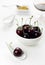 Cherries white spoon and bowl, sherry glass, sugar