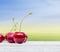 Cherries on white table on sky background