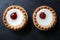 Cherry bakewell tarts in foil case on dark background looking like eyes