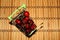 Cherry berries in a plate on the background of a defocus wooden