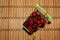 Cherry berries in a plate on the background of a defocus wooden