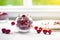 Cherry berry in a vase. Cherry berry in a transparent plate on a light background . Summer red berries.