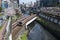 Cherry Blossom floating in a river with train tunnel in Tokyo, Japan during Spring