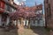 Cherry blossom in an old square with a medieval well in spring