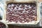 Cherry brownie batter in tin ready for the oven