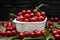 cherry cherries bowl with leaves on wooden desktop table. water drops on Fresh sour cherry