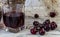 Cherry and cherry juice or wine on a wooden table, a decanter and a glass with juice, a basket with cherries